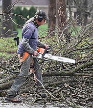 A worker cut up downed tress lying across the road following severe storms that passed through Prospect, Kentucky, Tuesday, April 2.
Mandatory Credit:	Timothy D. Easley/AP via CNN Newsource