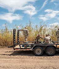 Texas National Guard soldiers repair damaged fencing on the banks of the Rio Grande in Eagle Pass, Texas, on March 21.
Mandatory Credit:	Brandon Bell/Getty Images via CNN Newsource