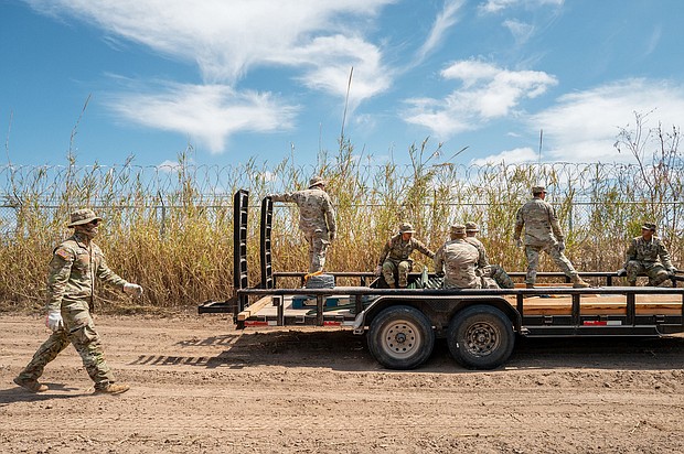 Texas National Guard soldiers repair damaged fencing on the banks of the Rio Grande in Eagle Pass, Texas, on March 21.
Mandatory Credit:	Brandon Bell/Getty Images via CNN Newsource