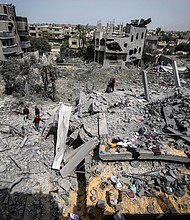 Palestinians inspect the damage to a residential building after an Israeli airstrike in the Maghazi refugee camp, central Gaza Strip, Friday, March 29, 2024.
Mandatory Credit:	Ismael Abu Dayyah/AP via CNN Newsource