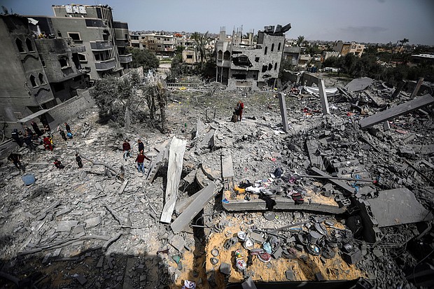 Palestinians inspect the damage to a residential building after an Israeli airstrike in the Maghazi refugee camp, central Gaza Strip, Friday, March 29, 2024.
Mandatory Credit:	Ismael Abu Dayyah/AP via CNN Newsource