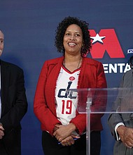 Ted Leonsis, right, owner of the Washington Wizards NBA basketball team and Washington Capitals NHL hockey team, speaks during a news conference with Washington, D.C. Mayor Muriel Bowser, left, and D.C. Council Chairman Phil Mendelson, center, at the Capitol One Arena in Washington, Wednesday, March 27.