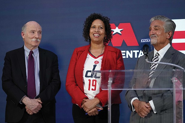 Ted Leonsis, right, owner of the Washington Wizards NBA basketball team and Washington Capitals NHL hockey team, speaks during a news conference with Washington, D.C. Mayor Muriel Bowser, left, and D.C. Council Chairman Phil Mendelson, center, at the Capitol One Arena in Washington, Wednesday, March 27.