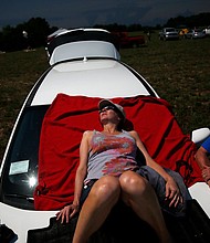 During a total solar eclipse, surroundings may start to have a grayish sepia-tone look a few minutes before totality. That's the best time to view an optical illusion known as the Purkinje effect, best-observed in red and green colors.
Mandatory Credit:	Jessica Rinaldi/The Boston Globe/Getty Images via CNN Newsource