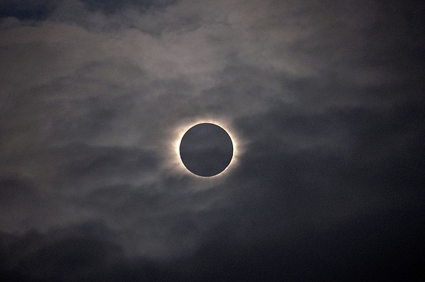 A total solar eclipse is visible through thin clouds as seen from Vágar on the Faroe Islands, Friday, March 20, 2015.
Mandatory Credit:	Eric Adams/AP via CNN Newsource
