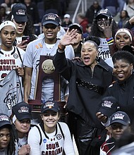 South Carolina head coach Dawn Staley celebrates with the team after beating the Oregon State Beavers in the Elite Eight round.
Mandatory Credit:	Andy Lyons/Getty Images via CNN Newsource