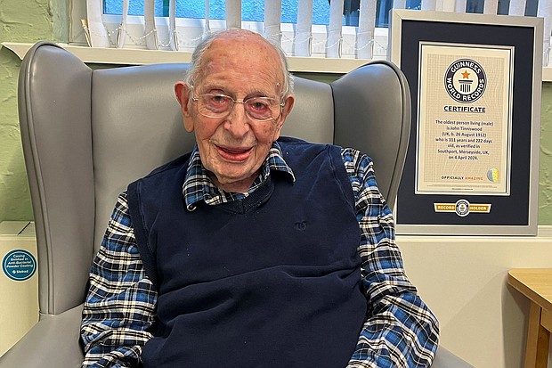John Alfred Tinniswood, 111, poses with his certificate from Guinness World Records in Southport, England, on Thursday.
Mandatory Credit:	Guinness World Records via Reuters via CNN Newsource