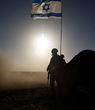 Soldiers with the Israel Defense Forces stand near a military vehicle on March 4, 2024.
Mandatory Credit:	Amir Levy/Getty Images via CNN Newsource