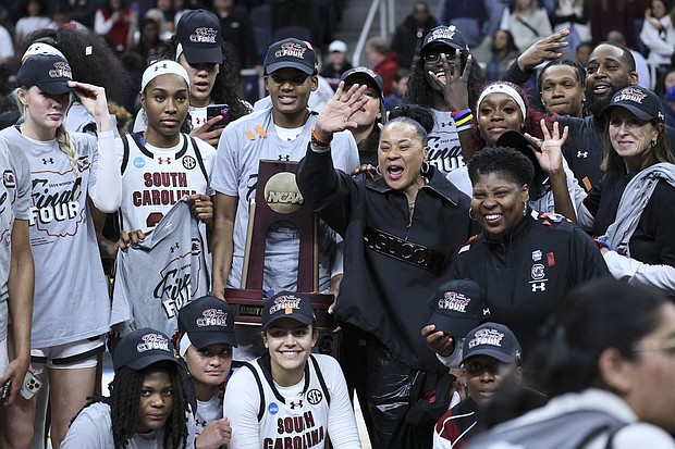 South Carolina head coach Dawn Staley celebrates with the team after beating the Oregon State Beavers in the Elite Eight round.
Mandatory Credit:	Andy Lyons/Getty Images via CNN Newsource