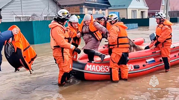 Emergency workers evacuate a local resident after a part of a dam burst causing flooding, in Orsk, Russia.
Mandatory Credit:	Russian Emergency Ministry Press Service via AP via CNN Newsour