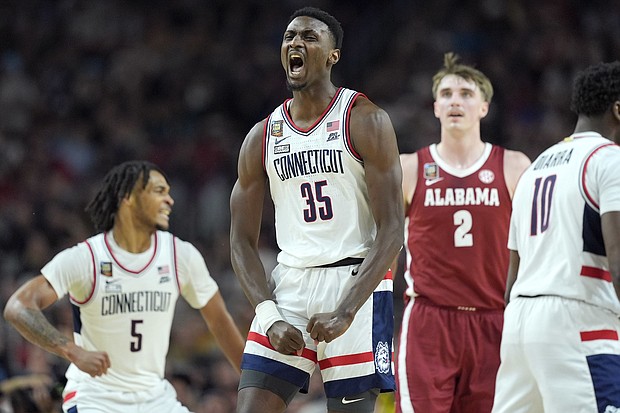 UConn forward Samson Johnson celebrates a basket during the second half of the Final Four game against Alabama.
Mandatory Credit:	Brynn Anderson/AP via CNN Newsource