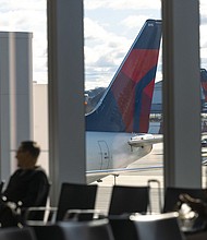 Delta Air Lines planes line up at New York's LaGuardia Airport in an April 2024 photo.
Mandatory Credit:	Angus Mordant/Bloomberg/Getty Images via CNN Newsource