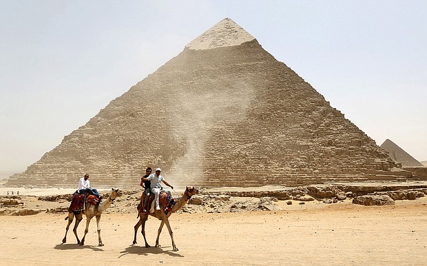 Tourists ride on camels next to the Pyramid of Khufu on the Great Pyramids of Giza, on the outskirts of Cairo, on April 27, 2015. A total eclipse will cross over the pyramids in 2027.
Mandatory Credit:	Mohamed Abd El Ghany/Reuters via CNN Newsource