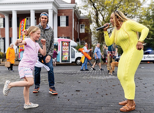 Dance like no one’s watching-Jade of The Love Movement performed at the Davis Avenue 
stage on Monument Avenue during the annual Easter on Parade on Sunday, March 31. Her singing prompted dancing from fans such as Carolina Morris, who was cheered on by her dad, Whit Morris. (Julianne Tripp/Richmond Free Press)