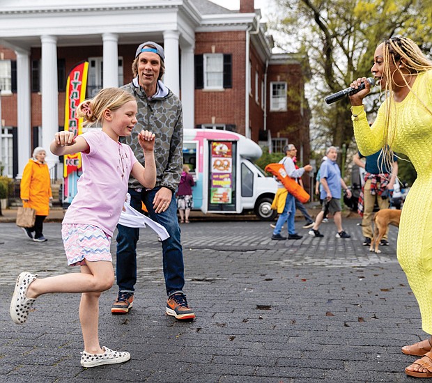 Dance like no one’s watching-Jade of The Love Movement performed at the Davis Avenue 
stage on Monument Avenue during the annual Easter on Parade on Sunday, March 31. Her singing prompted dancing from fans such as Carolina Morris, who was cheered on by her dad, Whit Morris. (Julianne Tripp/Richmond Free Press)