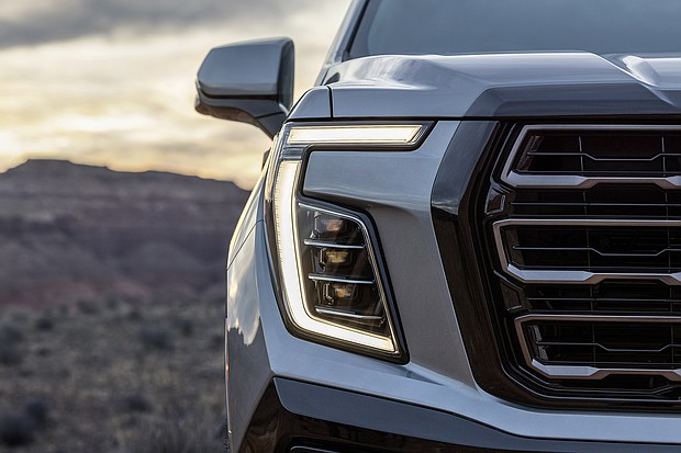 Exterior view of the 2025 GMC Yukon AT4, showcasing its refreshed front fascia, updated headlight and redesigned grille executions.