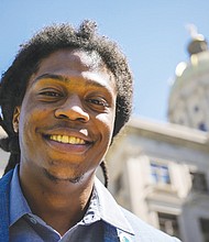 Davante Jennings poses for a photo at the state Capitol on March 28 in Atlanta. Not long ago, Mr. Jennings was not even an active voter. He had given up on polictics after the 2016 presidential election — his first time voting. But he was targeted by the New Georgia Project ahead of the 2022 elections and now helps reach out to would be voters.