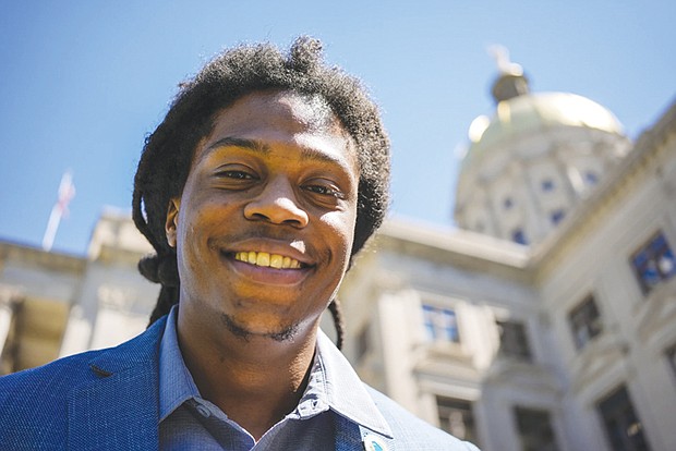Davante Jennings poses for a photo at the state Capitol on March 28 in Atlanta. Not long ago, Mr. Jennings was not even an active voter. He had given up on polictics after the 2016 presidential election — his first time voting. But he was targeted by the New Georgia Project ahead of the 2022 elections and now helps reach out to would be voters.