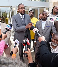 Attorney Malik Shabazz, center, speaks outside the federal courthouse in Jackson, Mississippi, after a sentencing hearing in March as his client, Michael Jenkins, listens.
Mandatory Credit:	Rogelio V. Solis/AP via CNN Newsource