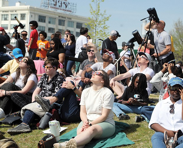 Hundreds gather on the front lawn of the Science Museum of Virginia along Broad Street in Richmond to take in the historic siting of a partial solar eclipse Monday, April 8, 2024.