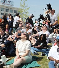 Hundreds gather on the front lawn of the Science Museum of Virginia along Broad Street in Richmond to take in the historic siting of a partial solar eclipse Monday, April 8, 2024.