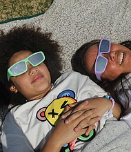 Lila Hunter, 10, of Newport News, left, had a day off from school, which she used to take in the historic partial solar eclipse with her aunt, Dawn Leigh Anderson, of Louisa County. They were among hundreds of other spectators on the front lawn of the Science Museum to see the partial eclipse.