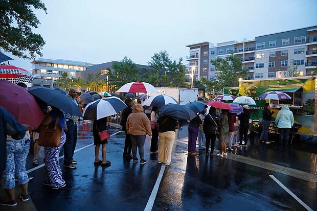 Attendees of the Taste of Mississippi event wait in line in the rain in Jackson, Mississippi.
Mandatory Credit:	Sarah Warnock/USA Today via CNN Newsource