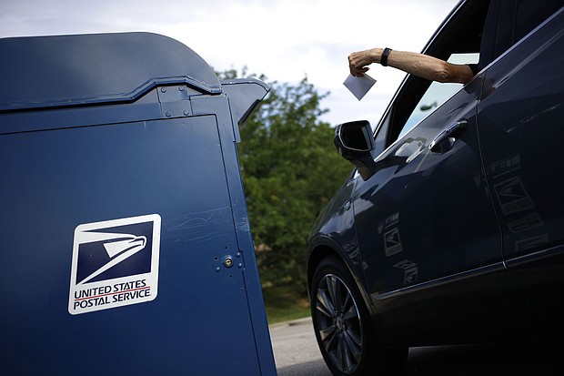 A motorist drops a letter into a USPS mail drop box at a post office in Kentucky in 2022.
Mandatory Credit:	Luke Sharrett/Bloomberg/Getty Images via CNN Newsource