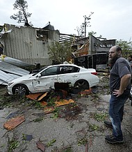 People survey a severely damaged business in Slidell, Louisiana, after severe storms swept through on Wednesday.
Mandatory Credit:	Gerald Herbert/AP via CNN Newsource