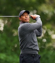 Tiger Woods of the United States plays his shot from the fourth tee during a practice round prior to the 2024 Masters Tournament at Augusta National Golf Club on April 09, in Augusta, Georgia.
Mandatory Credit:	Andrew Redington/Getty Images via CNN Newsour