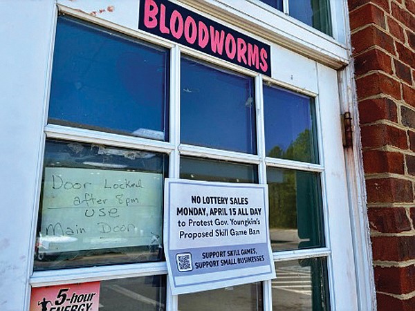 A sign posted outside a Henrico County convenience store informed customers that the business was not selling lottery tickets in protest of Gov. Glenn Youngkin’s tough approach to skill games.