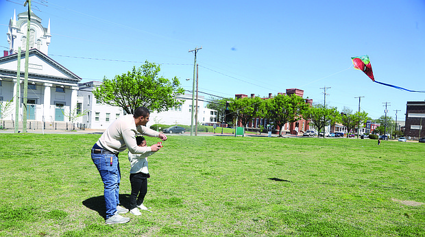 Nezirayh Lee, 5, and her father Immanuel Lee, 26, both of Henrico County, took advantage of the perfect kite-flying weather on April 13 at Abner Clay Park in Historic Jackson Ward.
