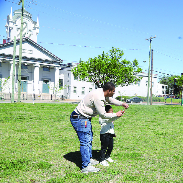 Nezirayh Lee, 5, and her father Immanuel Lee, 26, both of Henrico County, took advantage of the perfect kite-flying weather on April 13 at Abner Clay Park in Historic Jackson Ward.
