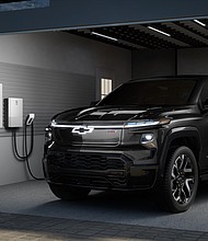 Rendering of a 2024 Chevrolet Silverado EV RST in a residential garage with anticipated GM Energy offerings. Simulated products shown. Actual production model may vary. Simulated vehicle shown. Actual production model may vary.