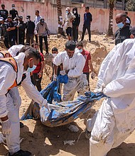 Palestinian health workers recover buried bodies from a mass grave at the Nasser Medical Hospital compound in Khan Younis, Gaza, on April 21.
Mandatory Credit:	Ahmad Salem/Bloomberg/Getty Images via CNN Newsource