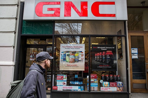 In this 2015 file photo, people walk past a GNC store on March 30, 2015 in New York City.
Mandatory Credit:	Andrew Burton/Getty Images/File via CNN Newsource