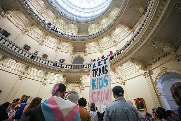 Equality Texas leadership drops a banner in the Capitol rotunda as LGBTQ rights activists protest SB14 at the Capitol of Texas in May 2023. The state of Texas is suing the Biden administration over recently announced federal protections for LGBTQ+ students.
Mandatory Credit:	Mikala Compton/American-Statesman/USA Today Network via CNN Newsource