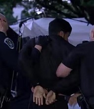 On Tuesday afternoon, an already tense situation escalated after the American flag was lowered and replaced with a Palestinian flag on the main quad. Dozens of police officers entered the main quad along with UNC Interim Chancellor Lee Roberts.
Mandatory Credit:	WRAL via CNN Newsource