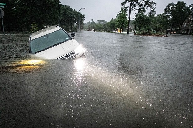 An SUV is stranded in a ditch along a stretch of street flooding during a severe storm Thursday in Spring, Texas.
Mandatory Credit:	Brett Coomer/Houston Chronicle/Getty Images via CNN Newsource