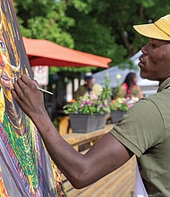 Artist Xolani Sivundla paints during ART 180’s Block Party on May 3 on Marshall Street. Mr. Sivundla is from Cape Town, South Africa, and is in a six-month Artist Residency with Art 180. The group brings together young artists with seasoned professionals.