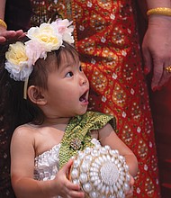 Anya Tangtrakul, age 21 months, poses May 4 with other Thailand dancers at the 26th Annual Asian American Festival held at the Richmond Convention Center.