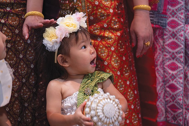 Anya Tangtrakul, age 21 months, poses May 4 with other Thailand dancers at the 26th Annual Asian American Festival held at the Richmond Convention Center.