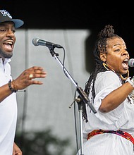 Nickey McMullen (right) and Gerald Golden Jr. (left) perform with Kevin Davis & Ban Caribe during the 23rd Annual ¿Qué Pasa? Festival at Brown’s Island on Saturday, May 4.