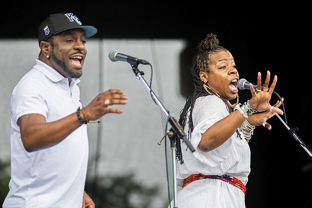 Nickey McMullen (right) and Gerald Golden Jr. (left) perform with Kevin Davis & Ban Caribe during the 23rd Annual ¿Qué Pasa? Festival at Brown’s Island on Saturday, May 4.