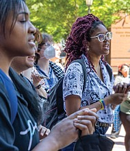 Isabella Cofield (wearing glasses), a second-year student at Virginia Commonwealth
University, gathers with others Thursday, May 2, outside VCU’s James Branch Cabell
Library. During the gathering, the crowd chanted, “The people united will never be
defeated,” and “Disclose, divest, we will not stop, we will not rest.”