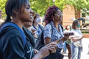 Isabella Cofield (wearing glasses), a second-year student at Virginia Commonwealth
University, gathers with others Thursday, May 2, outside VCU’s James Branch Cabell
Library. During the gathering, the crowd chanted, “The people united will never be
defeated,” and “Disclose, divest, we will not stop, we will not rest.”