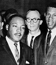 Rev. Dr. Martin Luther King, Jr. with Rev. William A. Lawson, and others looking on