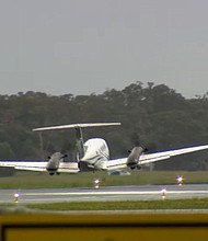 A plane makes successful wheels-up emergency landing in Newcastle, Australia after circling airport for hours, on May 13.
Mandatory Credit:	Nine News via CNN Newsource