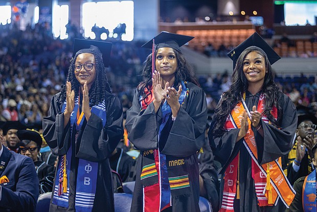 Taylor Alexis Collins, Alexis McNair and Aliyah Mariah Mayers stand to be recognized as the highest ranking graduates during Virginia State University’s Spring Commencement ceremony.