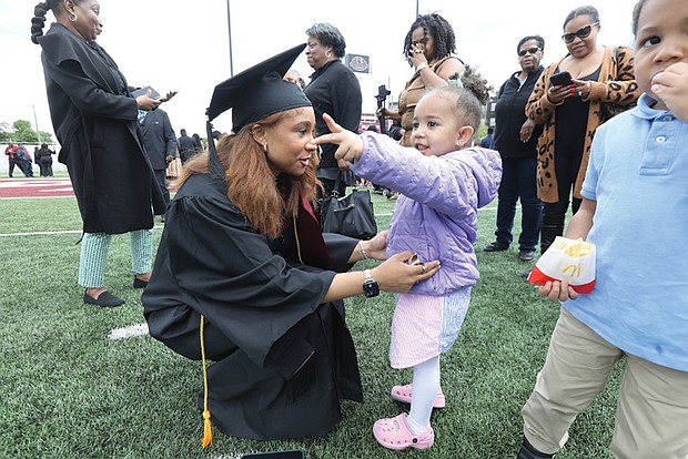 Virginia Union University’s 2024 undergraduate Valedictorian Brittani Martin, left, a bachelor of social work recipient from Potomac, Md., chats with her 2-year-old cousin Ariella Gleaton. following VUU’s 125th commencement exercises Saturday, May 11 at Hovey Field. Her big brother, 4-year-old Jonah Gleaton, was also there along with a host of other family members in town to celebrate their valedictorian speaker.